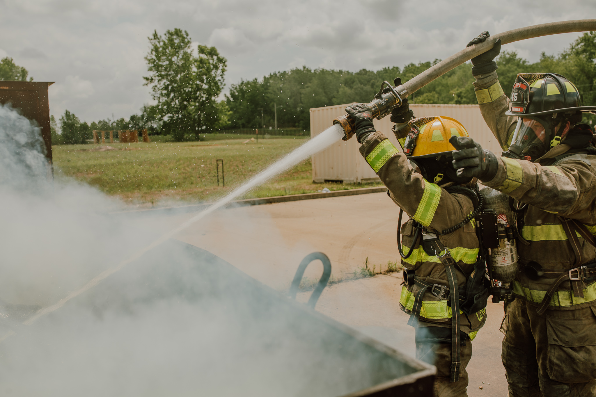 A phot of firefighters extinguishing a fire during a training exercise