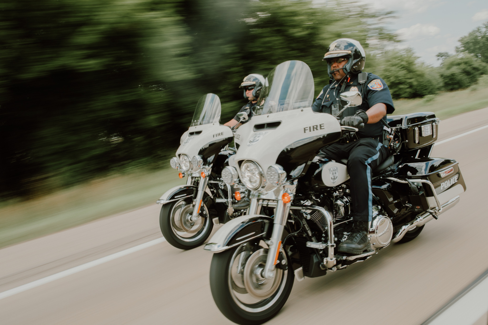 A photo of two Public Safety Officers riding motorcycles