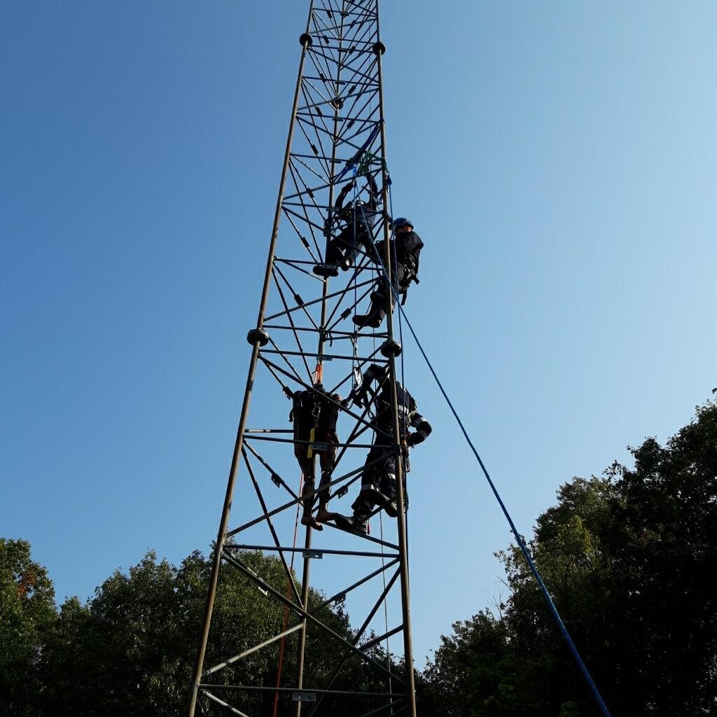 Photo of the KDPS Technical Rescue Team climbing a tower. 